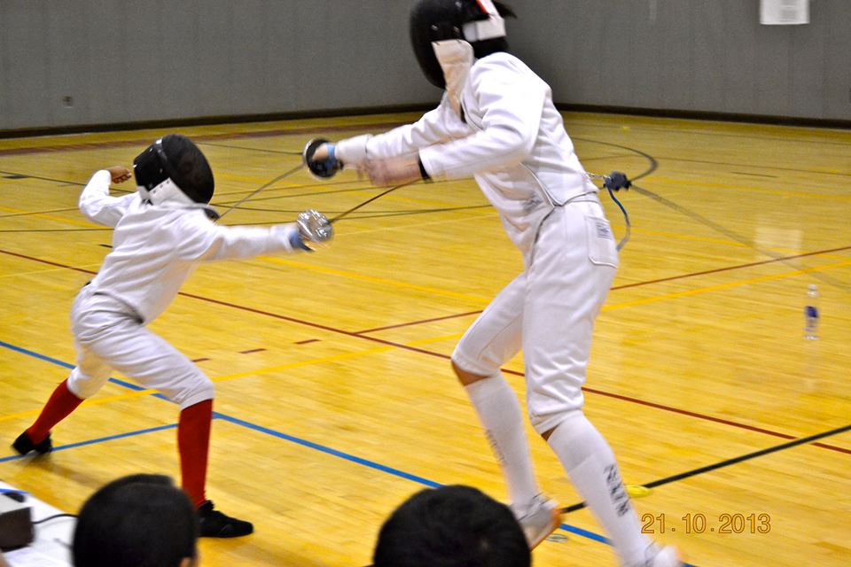 Senior epee captain Jordan Brandwein (on right) lunges at his Jamaica opponent. Photo courtesy of Jordan Brandwein