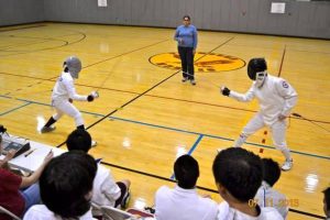 Sophomore epeeist David Zarowin faces off QHST fencer. Photo by Jordan Brandwein.