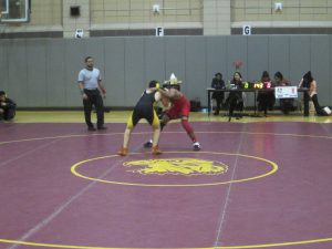 Senior Daniel Plotkin wrestles against Jamaica student. Photo Credit: Michelle Gan.