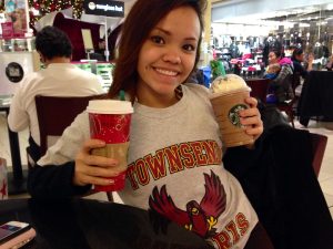 Junior Jennie Kablar poses with a peppermint mocha and a peppermint frappuccino from Starbucks.