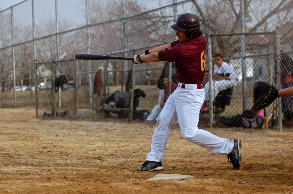 Junior Charlie Bennett swings the bat at the plate. Photo by Kari Iocolano.